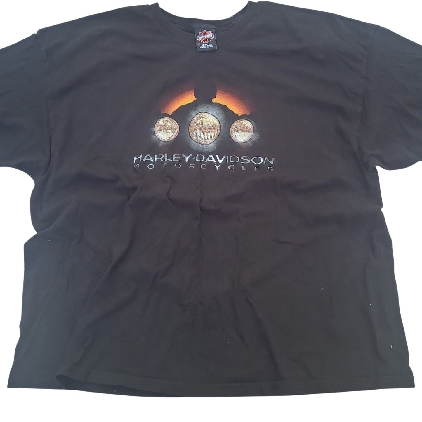 Black vintage Harley Davidson shirt featuring a motorcycle headlight design and Harley Davidson logo