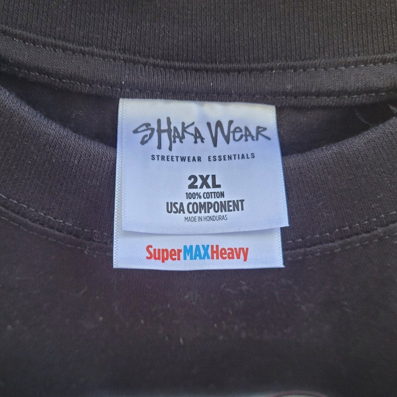 Close up of Shaka Wear label on black Virginia is for Legends Y2k tee size 2XL made of 100 percent cotton