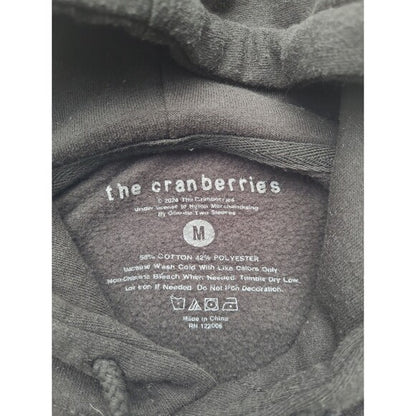 Inside label of Cranberries 1994 tour hoodie showing fabric details and care instructions