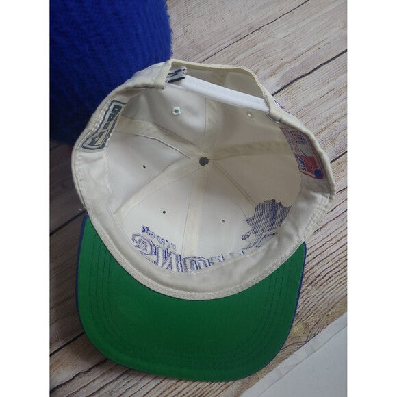 Inside view of vintage Sports Specialties Lions hat showing green brim and white interior with logo details